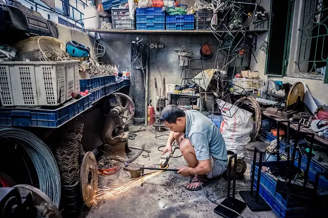 MAN WORKING IN GARAGE