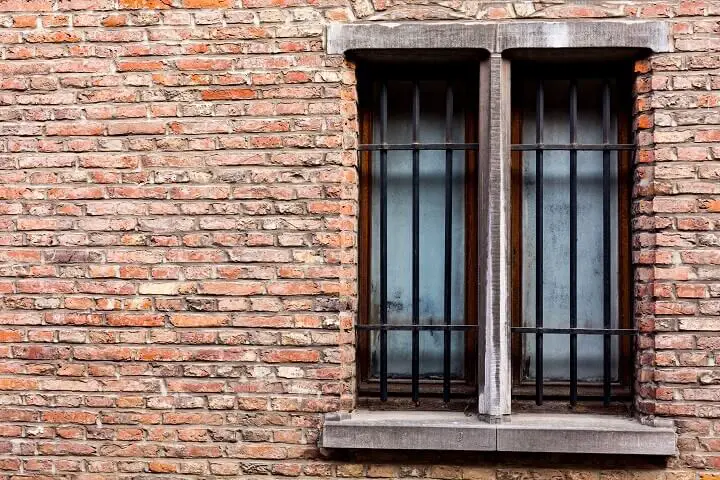 Brick Wall with Metal Bars on Window