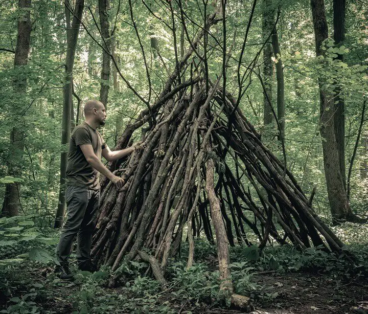 Man Building a Survival Shelter