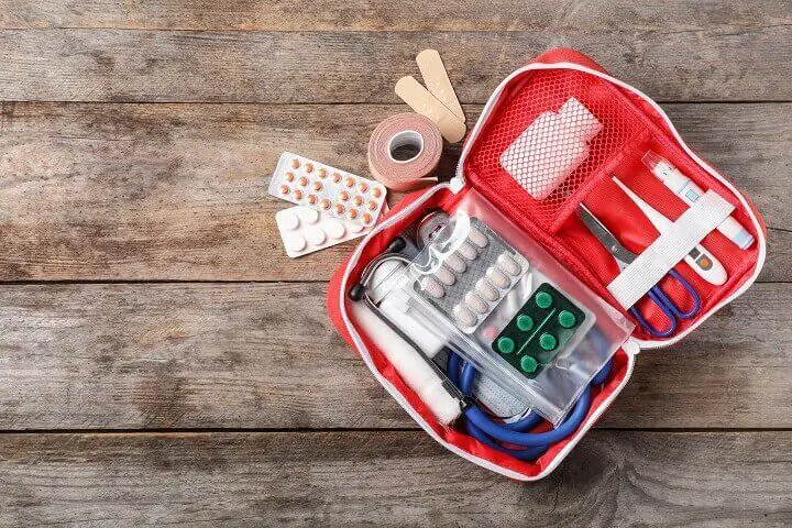 Small First Aid Kit On Wood Table