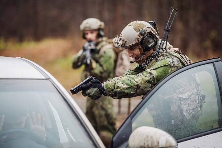 Soldier Pointing Gun at Suspicious Driver